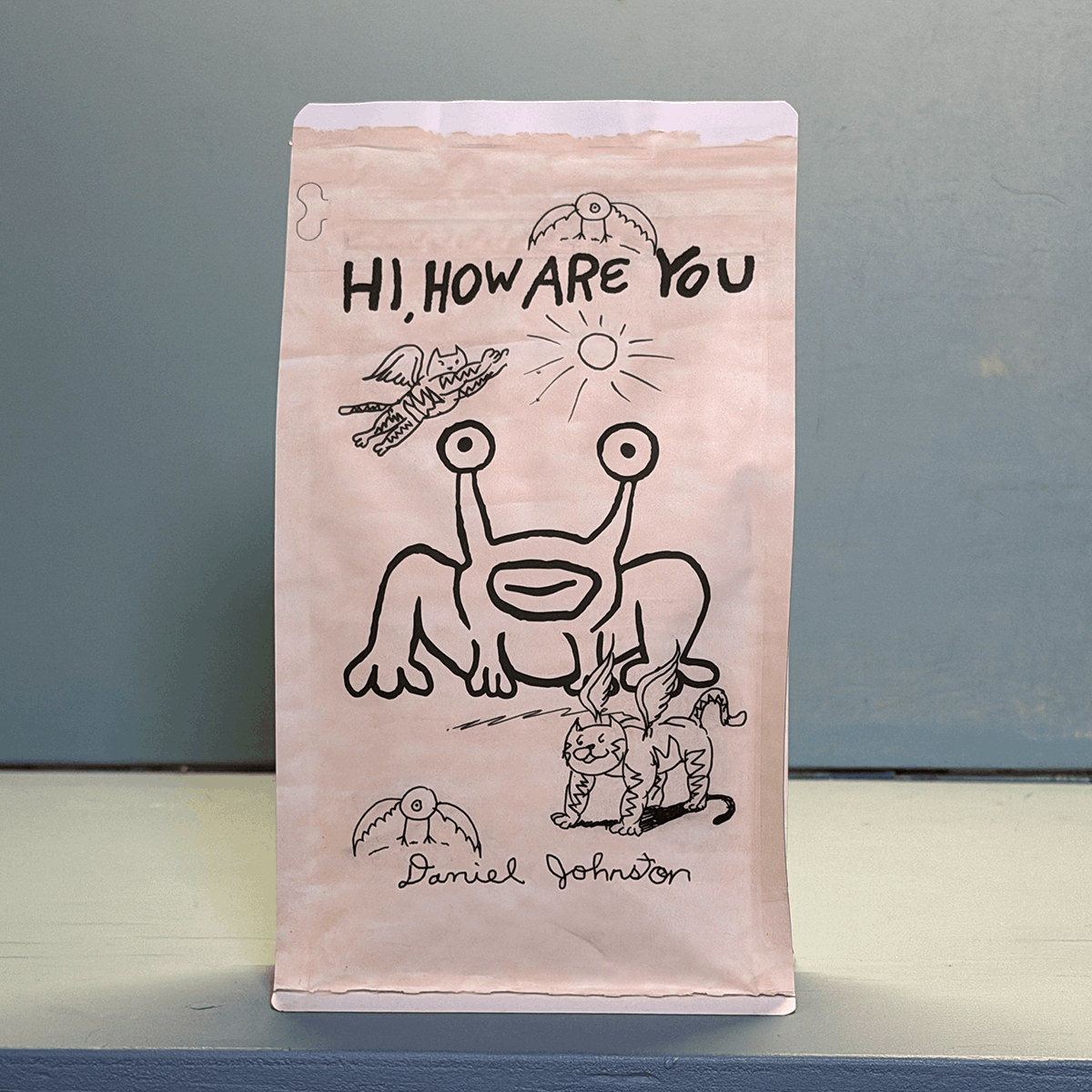 BEWM coffee bag featuring Daniel Johnston’s Hi, How Are You artwork